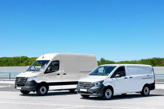 Two clean white work vans